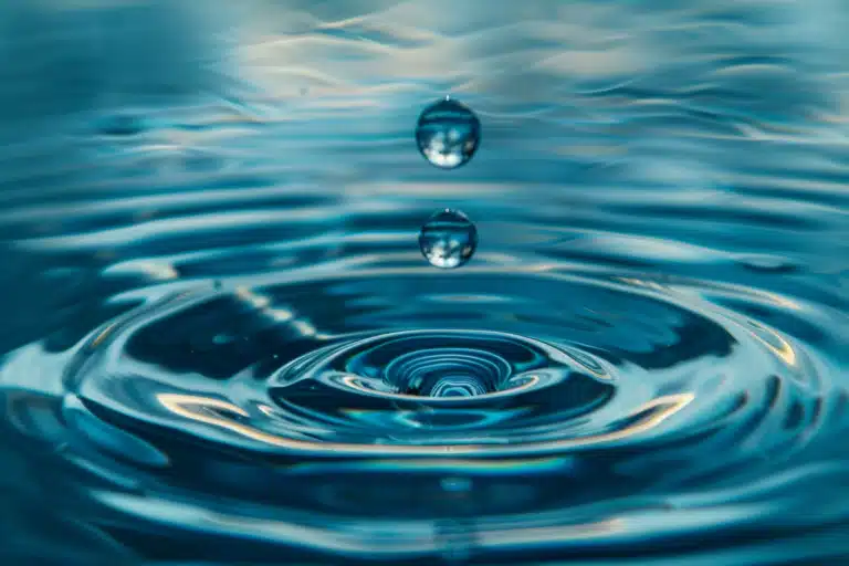 Water droplets suspended midair over a water ring