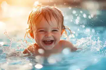 Joyful toddler splashing around in the water