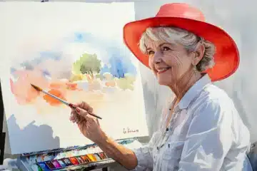 A watercolor painting of a woman painting with watercolors