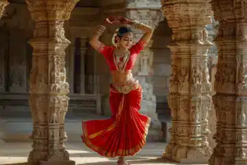 Indian woman dancing inside a temple of carved granite columns