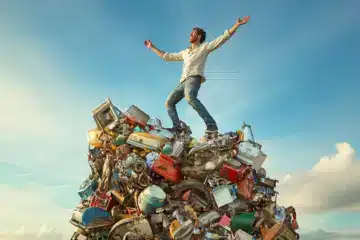 Proud man standing on a pile of junk