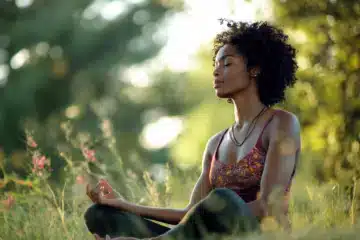 A woman enjoying a yoga meditation in a meadow