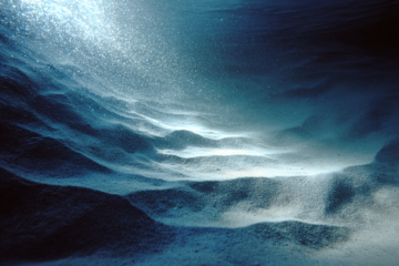Light reflecting on sand underwater
